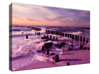Obraz na plátne Západ slnka nad morskou plážou vo fialovej